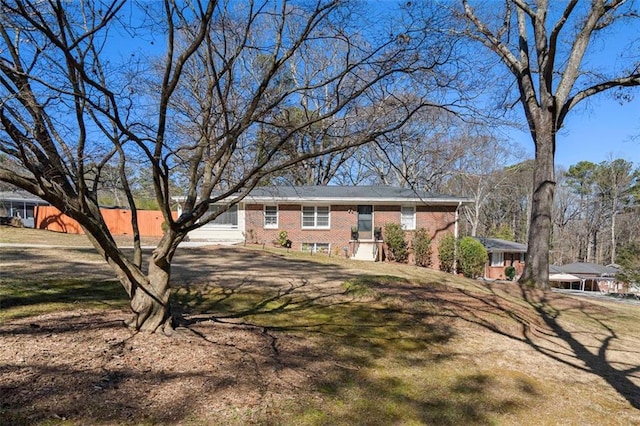 view of front of property featuring a front yard and brick siding