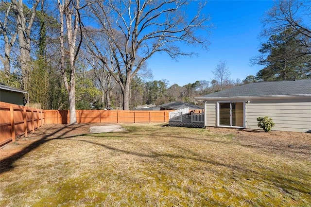 view of yard with a fenced backyard and a wooden deck