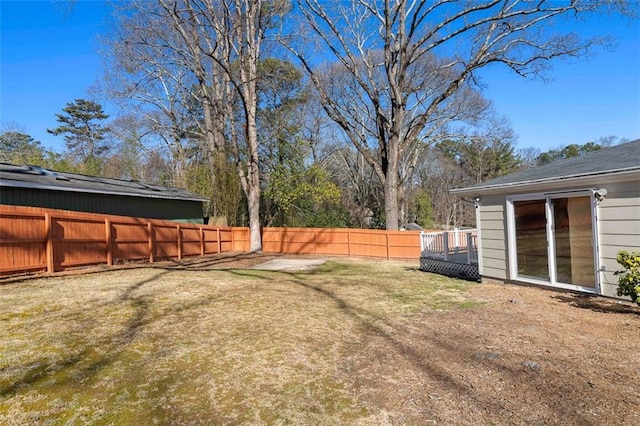 view of yard with fence and a deck