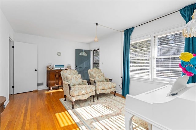 sitting room featuring wood finished floors and visible vents