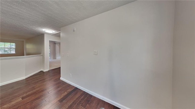 514 Jadetree Ln, Atlanta, GA 30349 - unfurnished room with dark wood-type flooring, baseboards, and a textured ceiling