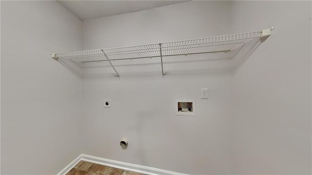514 Jadetree Ln, Atlanta, GA 30349 - laundry area featuring electric dryer hookup, washer hookup, baseboards, and wood finished floors