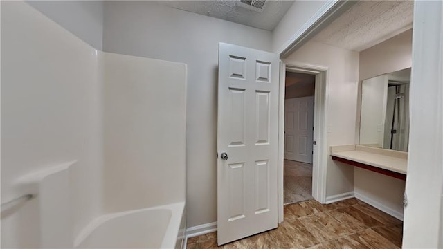 514 Jadetree Ln, Atlanta, GA 30349 - full bath featuring baseboards and a textured ceiling