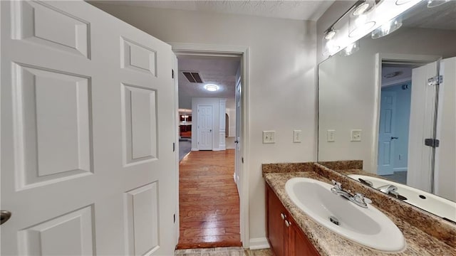 514 Jadetree Ln, Atlanta, GA 30349 - bathroom featuring vanity, wood finished floors, and baseboards