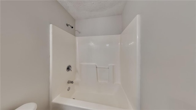 514 Jadetree Ln, Atlanta, GA 30349 - full bath with a textured ceiling, toilet, and  shower combination