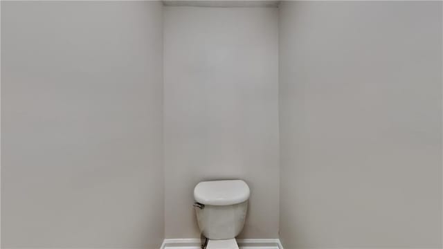 514 Jadetree Ln, Atlanta, GA 30349 - bathroom featuring baseboards and toilet
