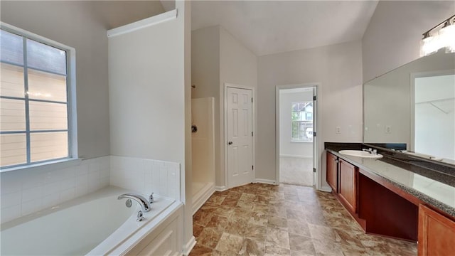 514 Jadetree Ln, Atlanta, GA 30349 - full bathroom featuring vanity, a bath, baseboards, and stone finish floors