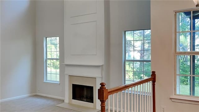 514 Jadetree Ln, Atlanta, GA 30349 - carpeted living room featuring a fireplace with flush hearth and baseboards