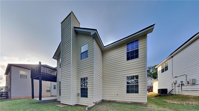 514 Jadetree Ln, Atlanta, GA 30349 - rear view of house with a chimney, a lawn, a patio, and a balcony