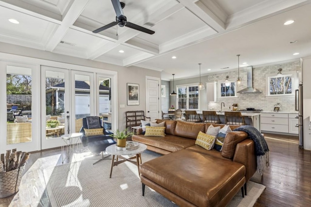 living area with beam ceiling, recessed lighting, coffered ceiling, and dark wood-style flooring