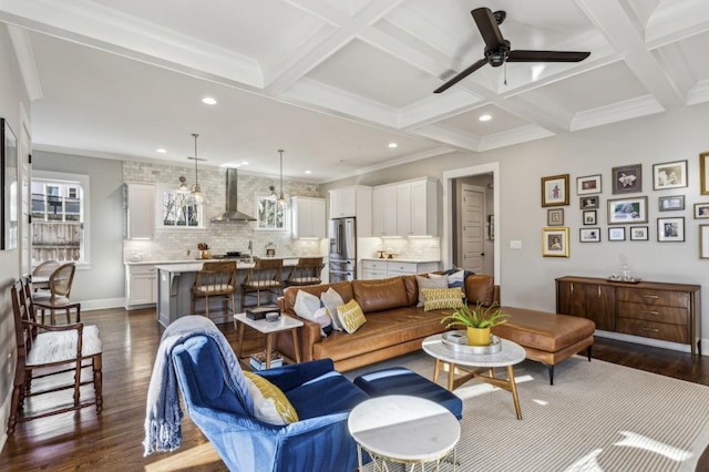 living area featuring dark wood-type flooring, ornamental molding, beam ceiling, recessed lighting, and coffered ceiling