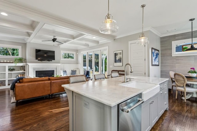 kitchen featuring coffered ceiling, dark wood finished floors, a sink, a glass covered fireplace, and beamed ceiling