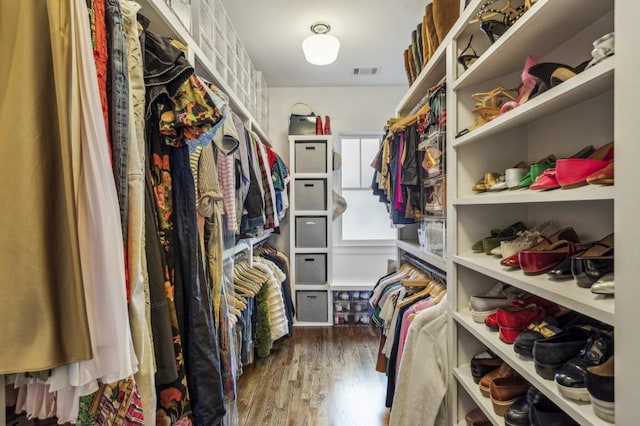 spacious closet featuring visible vents and wood finished floors