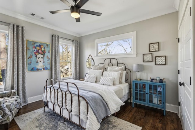 bedroom with visible vents, baseboards, and wood finished floors