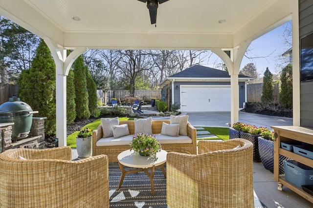 view of patio featuring an outbuilding, a ceiling fan, fence, an outdoor living space, and a grill