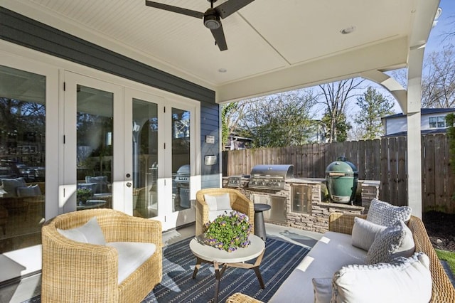 view of patio with area for grilling, an outdoor living space, french doors, and fence