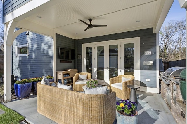 view of patio / terrace featuring a ceiling fan, fence, french doors, a grill, and exterior kitchen