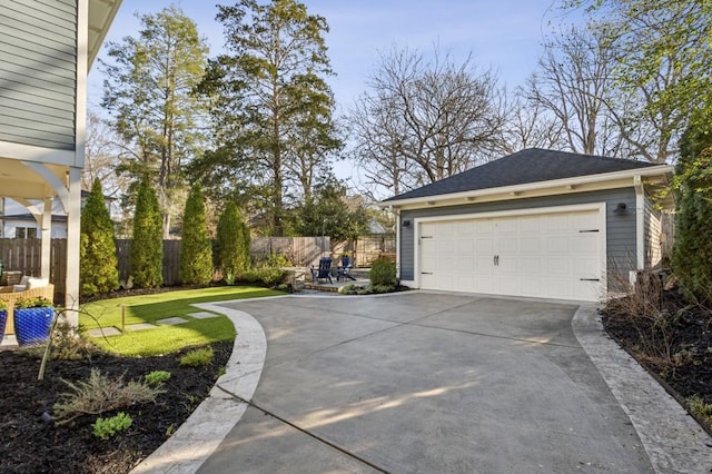 detached garage featuring fence