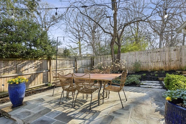 view of patio featuring outdoor dining area and a fenced backyard