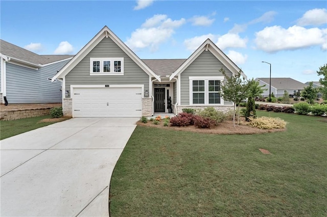 242 Aspen Way, Dallas, GA 30157 - view of front facade with concrete driveway, a front yard, stone siding, and an attached garage