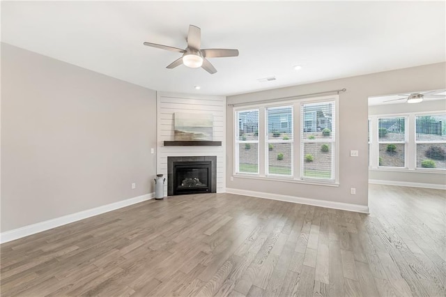 242 Aspen Way, Dallas, GA 30157 - unfurnished living room featuring ceiling fan, light wood-style floors, a large fireplace, and recessed lighting