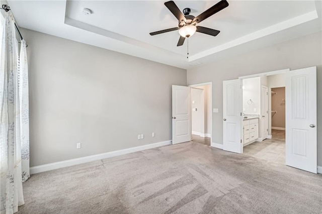 242 Aspen Way, Dallas, GA 30157 - unfurnished bedroom with a raised ceiling, light colored carpet, ensuite bath, and ceiling fan