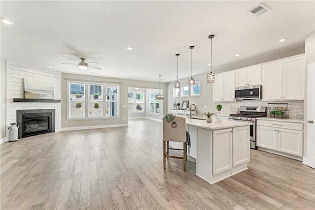 242 Aspen Way, Dallas, GA 30157 - kitchen featuring stainless steel appliances, open floor plan, light wood finished floors, and recessed lighting