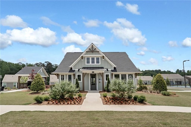 242 Aspen Way, Dallas, GA 30157 - view of front facade with board and batten siding, a front yard, and a shingled roof