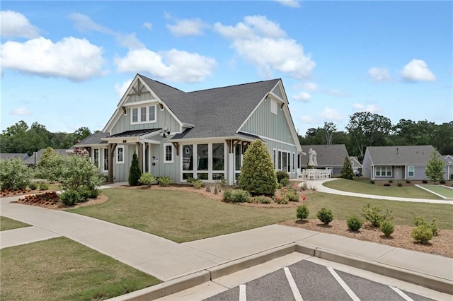 242 Aspen Way, Dallas, GA 30157 - view of front of property with board and batten siding, a front yard, and roof with shingles