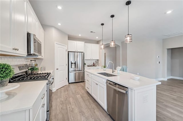 242 Aspen Way, Dallas, GA 30157 - kitchen featuring appliances with stainless steel finishes, light wood-style floors, tasteful backsplash, light countertops, and recessed lighting