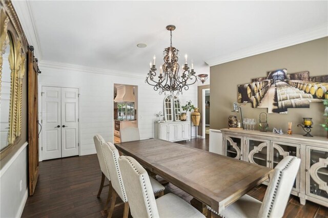 dining area featuring a chandelier, ornamental molding, and dark wood-style floors