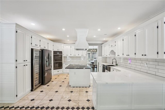kitchen featuring black appliances, a sink, white cabinets, decorative backsplash, and recessed lighting