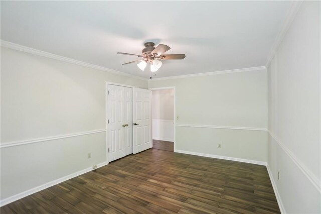 unfurnished bedroom with wood finished floors, baseboards, ornamental molding, ceiling fan, and a closet