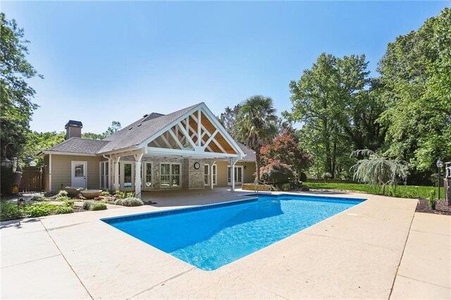 outdoor pool with a patio area and fence