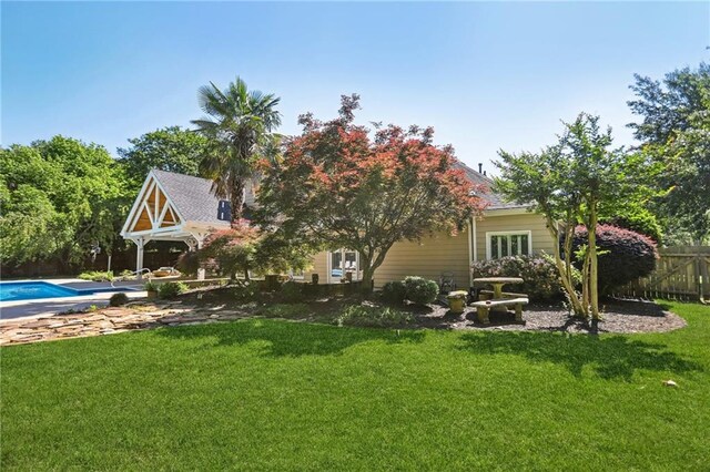 back of property with an outdoor pool