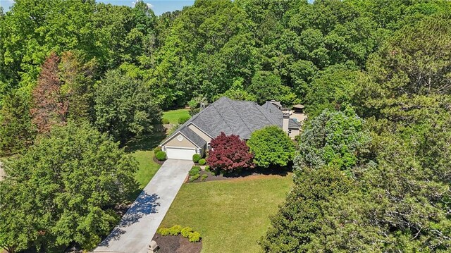 aerial view of property and surrounding area with a forest