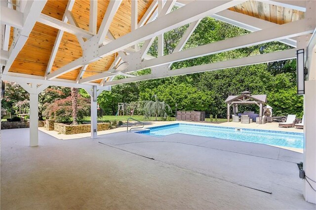 swimming pool with a gazebo, a patio area, and an outdoor hangout area
