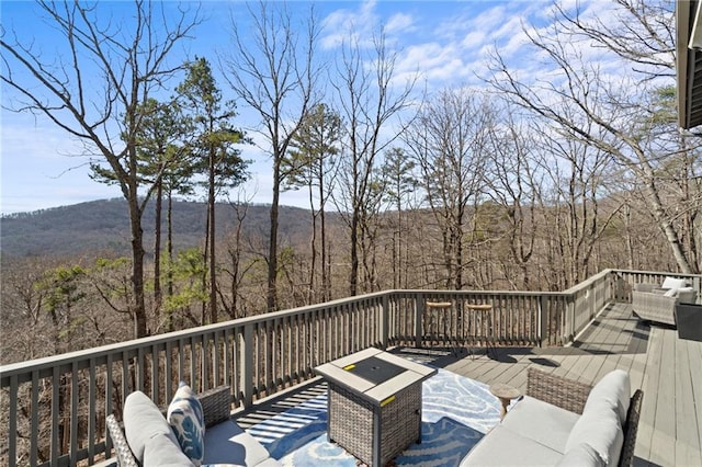 deck featuring a mountain view and an outdoor hangout area