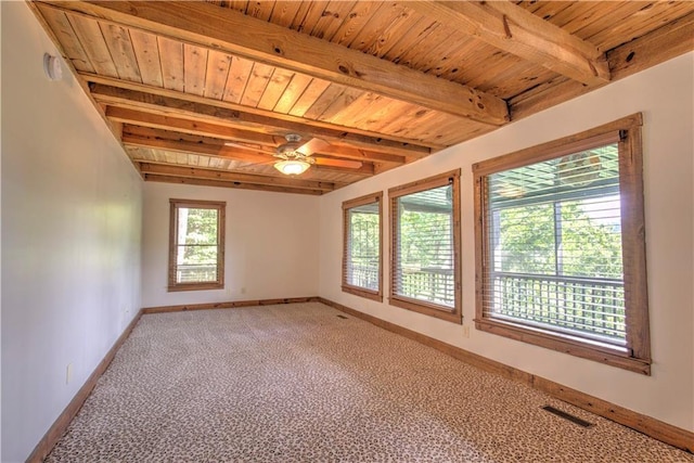 empty room featuring baseboards, beam ceiling, wood ceiling, and light carpet