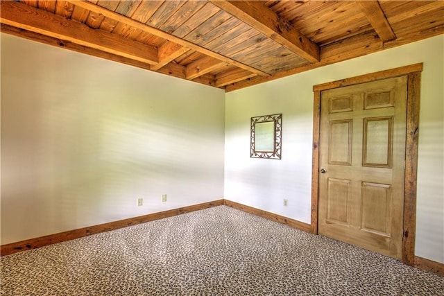 spare room featuring beamed ceiling, wooden ceiling, and baseboards