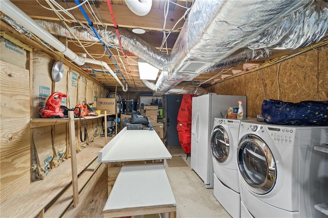 clothes washing area with washing machine and dryer