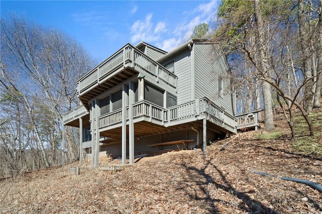 view of side of property with a balcony and a wooden deck