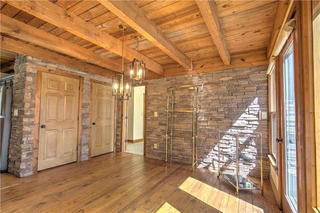 interior space featuring a notable chandelier, beamed ceiling, wood-type flooring, and wooden ceiling