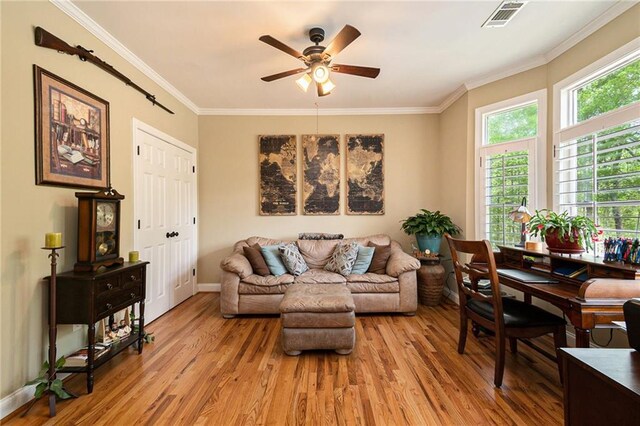 living room featuring ceiling fan, light hardwood / wood-style flooring, and ornamental molding