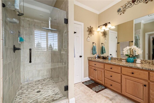 bathroom featuring a shower with shower door, vanity, and crown molding