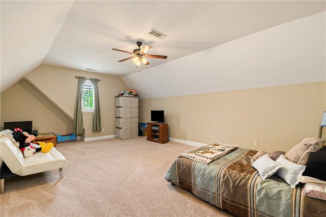 bedroom with lofted ceiling, ceiling fan, and light colored carpet