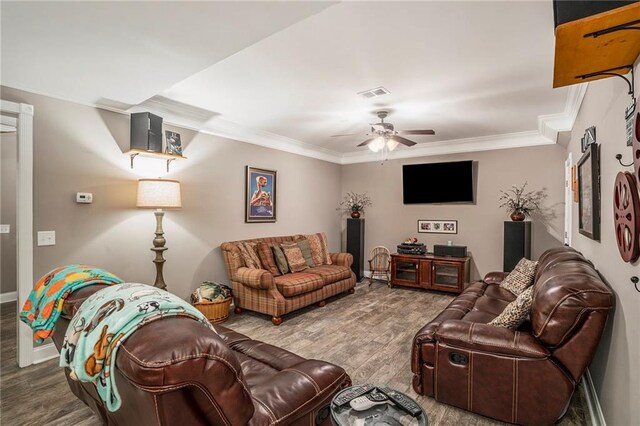 living room with crown molding, ceiling fan, and hardwood / wood-style flooring