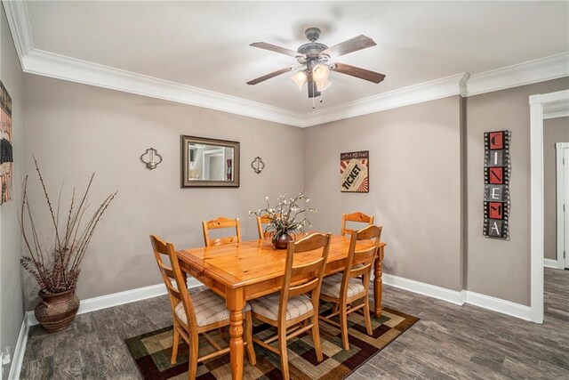 dining room with ceiling fan, ornamental molding, and dark wood-type flooring