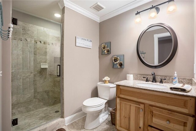 bathroom featuring ornamental molding, vanity, a shower with shower door, and toilet