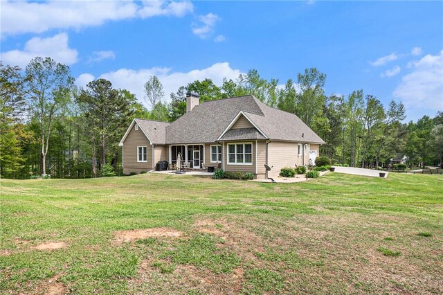 rear view of property with a lawn